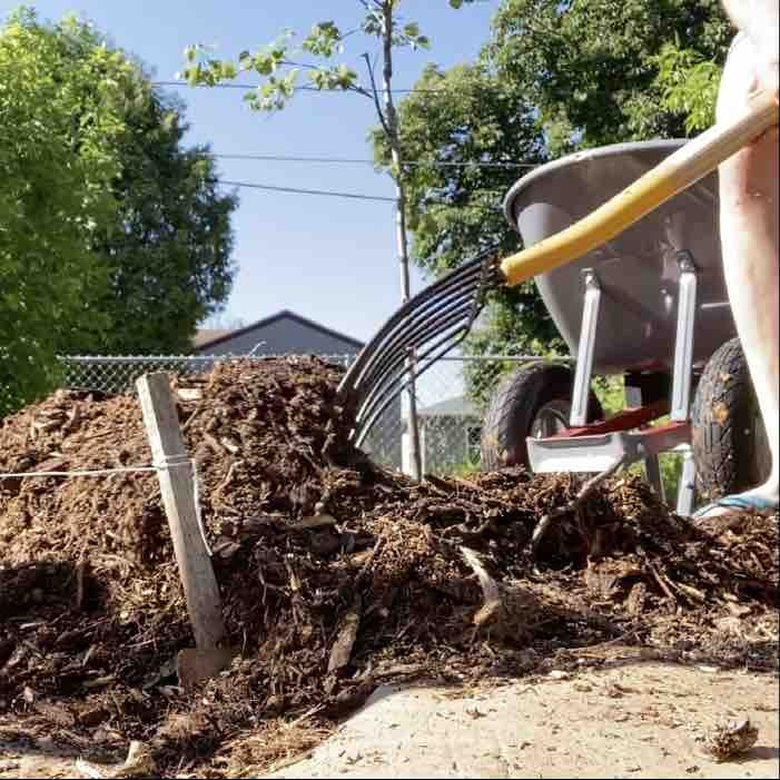 Wood chips being pushed by a pitchfork